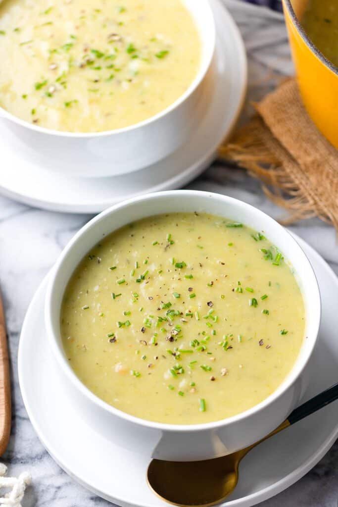 Leek and Potato Soup in a bowl on a small plate topped with chopped chives