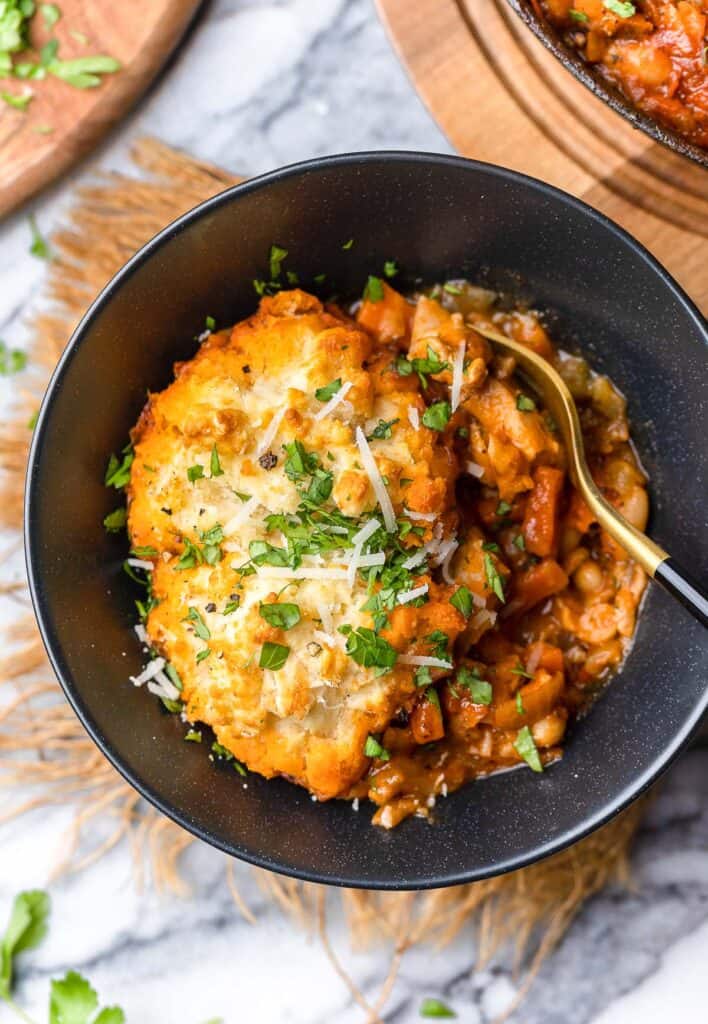 a serving of Italian Chicken Cobbler with a Parmesan Biscuit on top in a bowl 