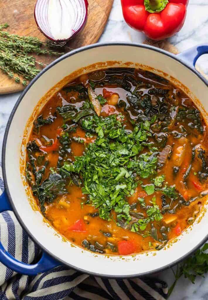 Spanish Chorizo and White Bean Soup in a large soup pot topped with freshly chopped parsley