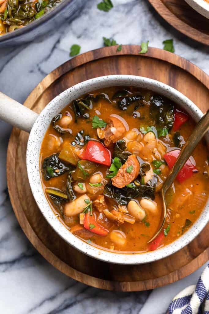 Spanish Chorizo and White Bean Soup in a soup bowl with a spoon