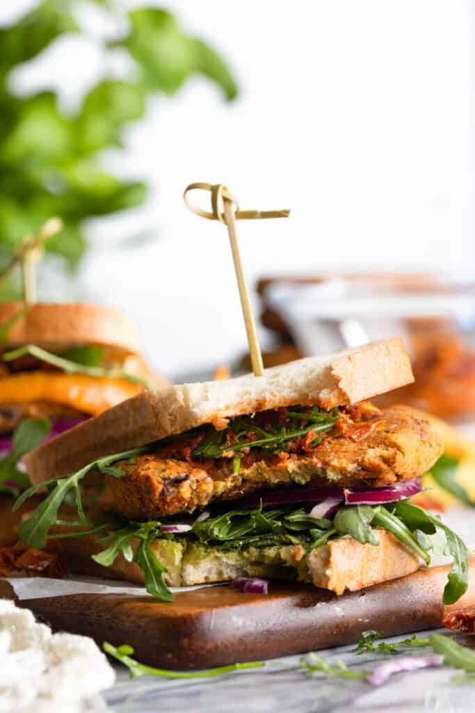 sun dried tomato chickpea burgers with a bite taken out 