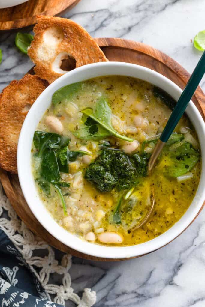 a with spring time pistou soup in a bowl with a dollop of pistou on top