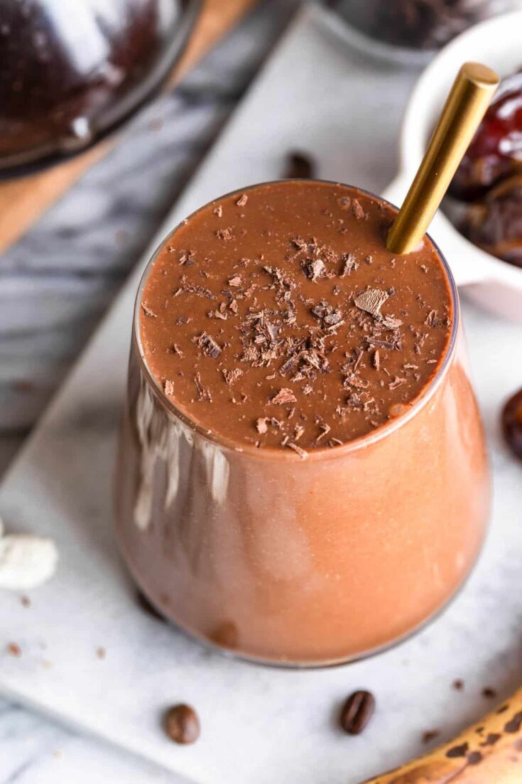 chocolate coffee smoothie in a glass topped with chocolate shavings