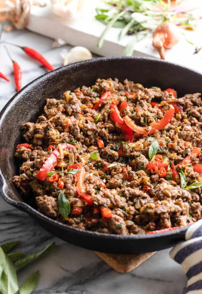 a cast iron skillet full of a thai basil beef stir fry