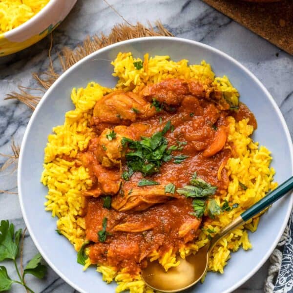 Moroccan Chicken Stew served over a bed of curried rice with parsley on top.