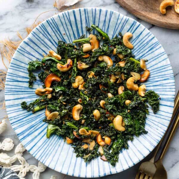 Garlic & Chili Sautéed Kale with Toasted Cashews in a bowl