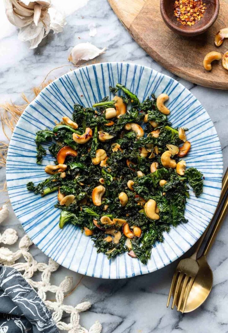 Garlic & Chili Sautéed Kale with Toasted Cashews in a bowl