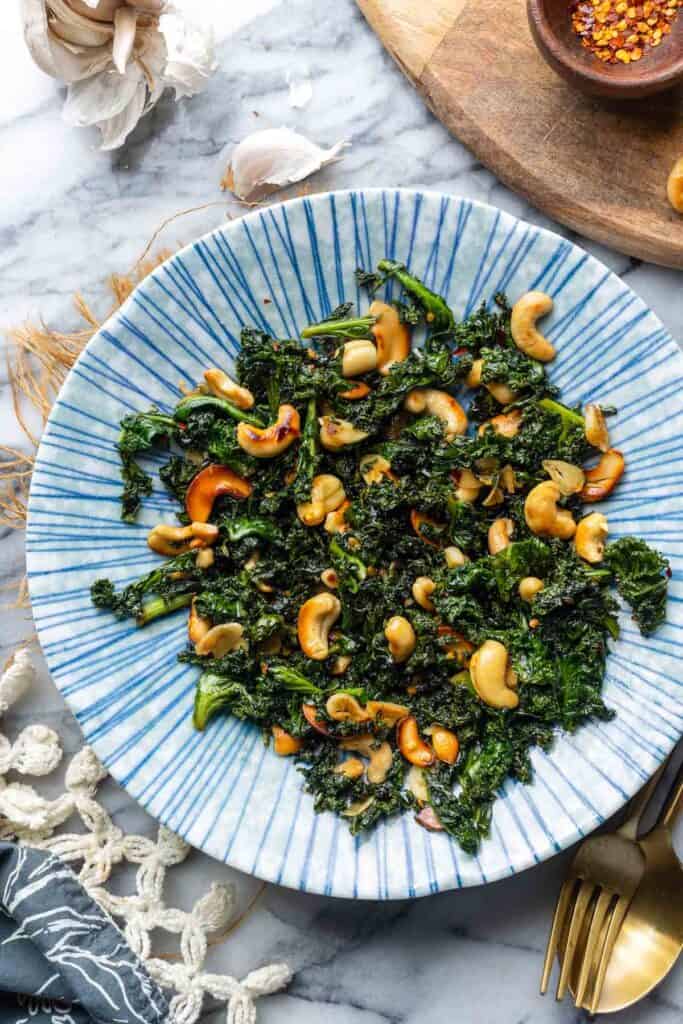 Garlic & Chili Sautéed Kale with Toasted Cashews in a serving bowl