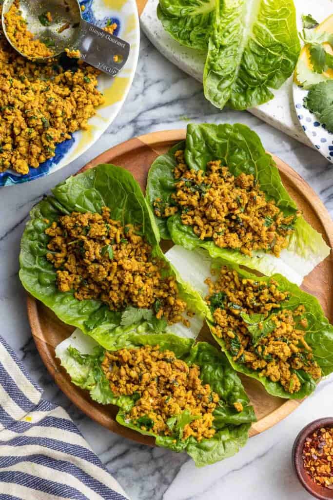 stir fried golden pork in lettuce wraps on a plate