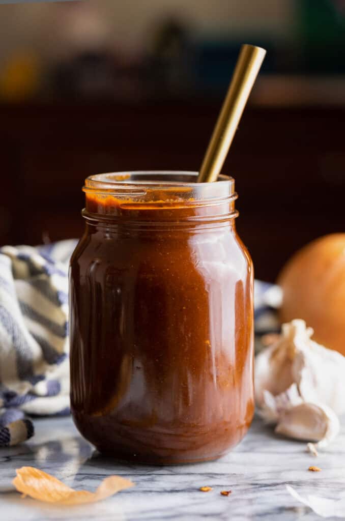 enchilada sauce in a jar with a spoon