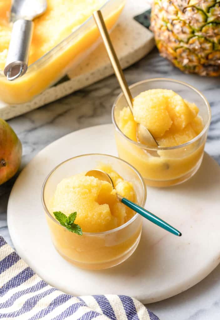 two small glasses of Pineapple Mango Sorbet with spoons