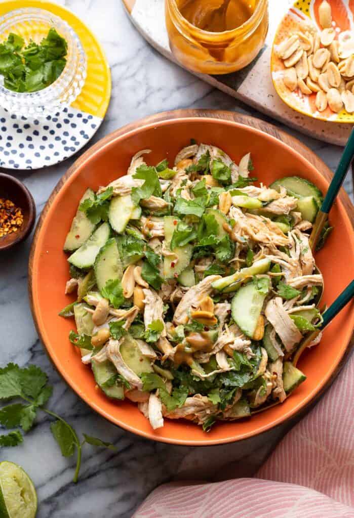 cucumber chicken salad mixed in a creamy peanut dressing in a salad bowl