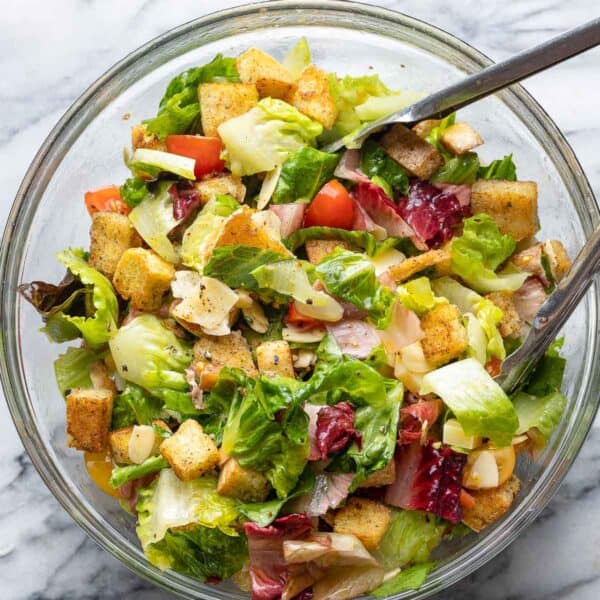 blt salad in a big salad bowl with tongs