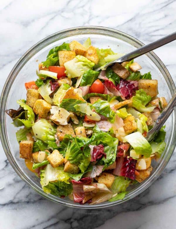 blt salad in a big salad bowl with tongs