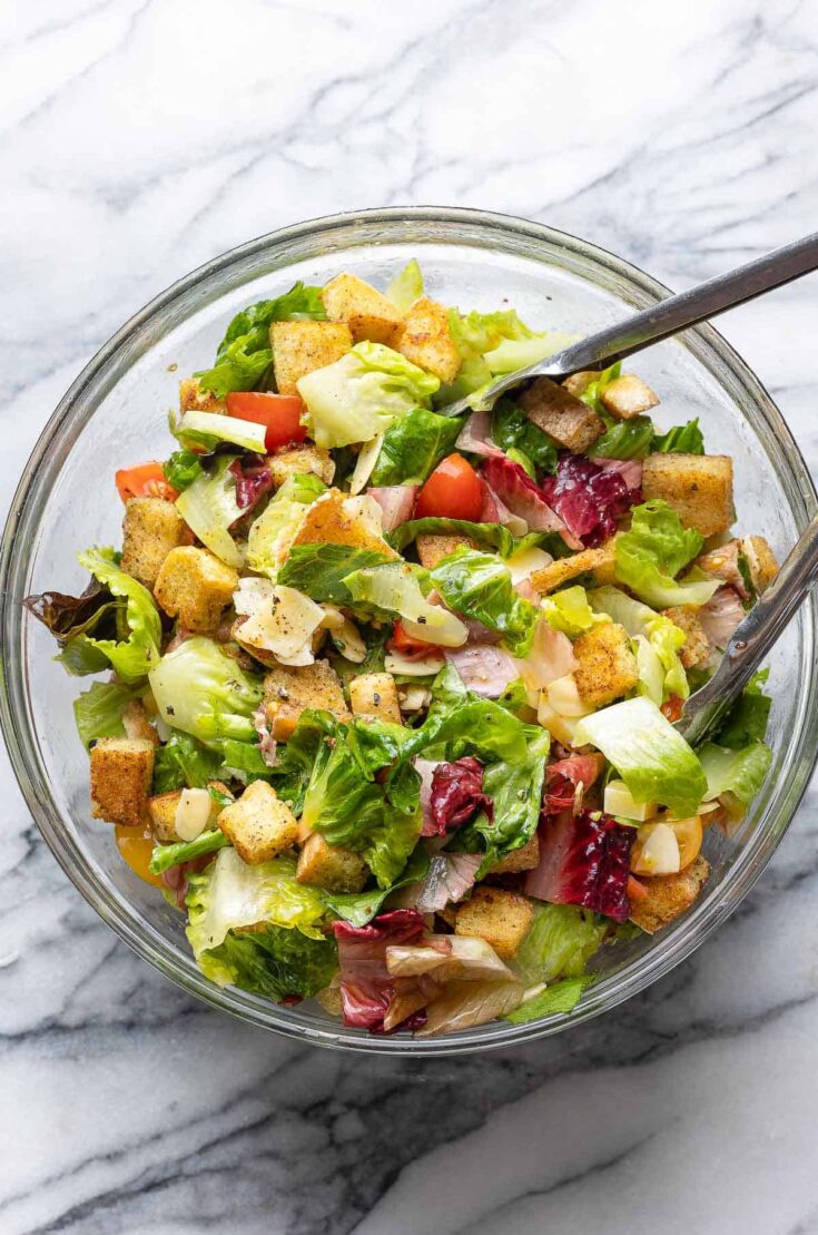 blt salad in a big salad bowl with tongs