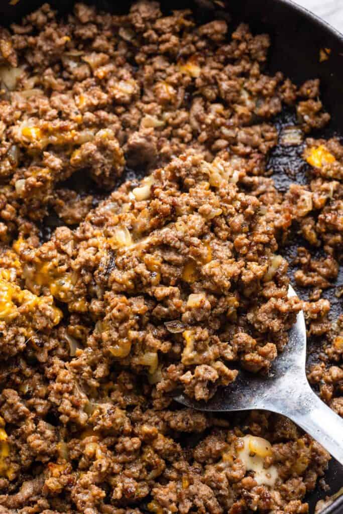 a spatula scooping up chopped cheese ground beef