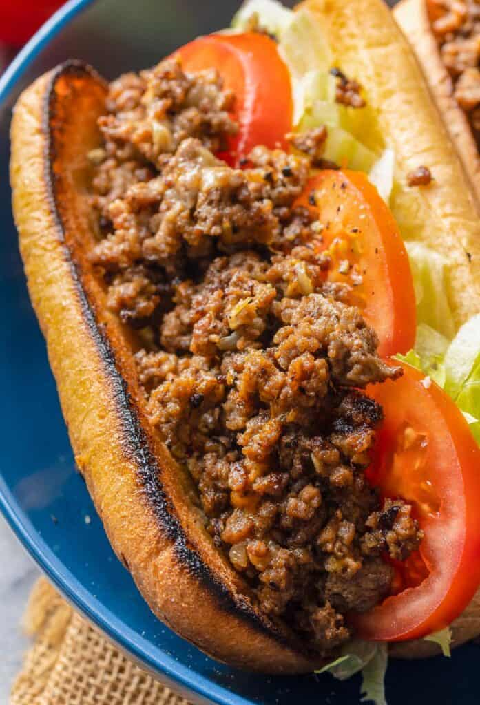 a close up image of a chopped cheese sandwich filling on a gluten free bun
