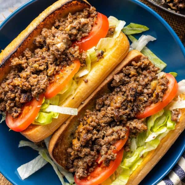 two Chopped Cheese Sandwiches on Gluten Free buns with lettuce and tomato