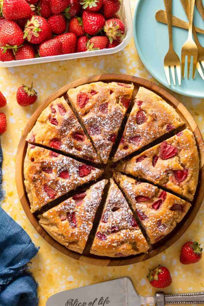Strawberry Cornmeal Ricotta Cake cut into 8 slices on a plate
