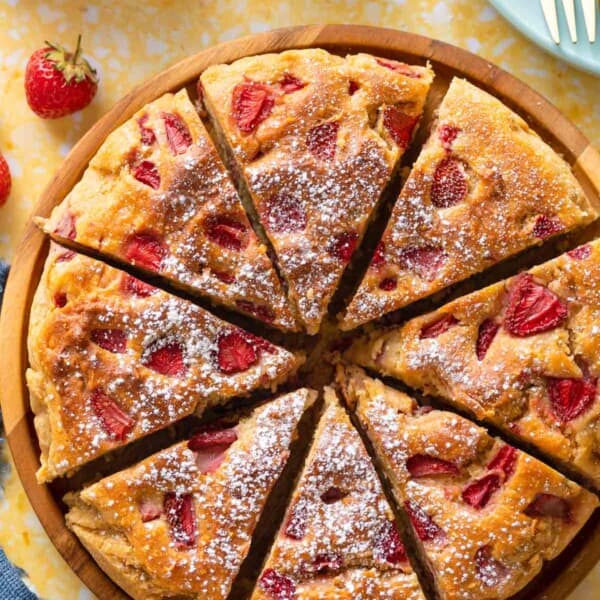 Strawberry Cornmeal Ricotta Cake cut into 8 slices and sprinkled with icing sugar