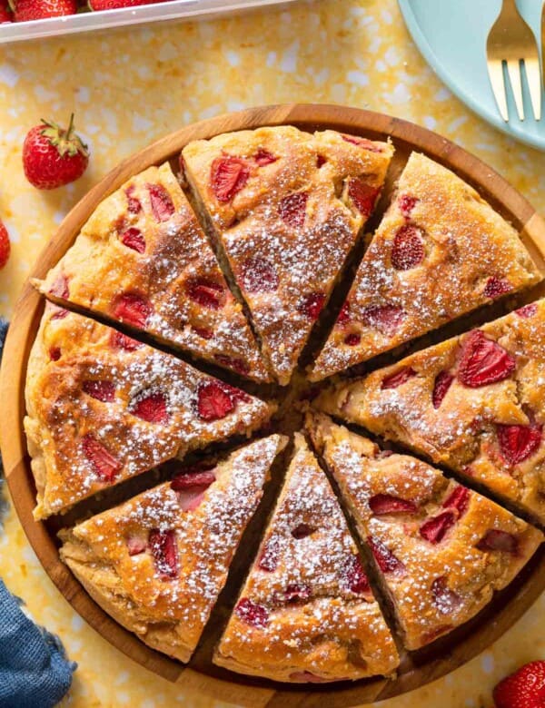 Strawberry Cornmeal Ricotta Cake cut into 8 slices and sprinkled with icing sugar