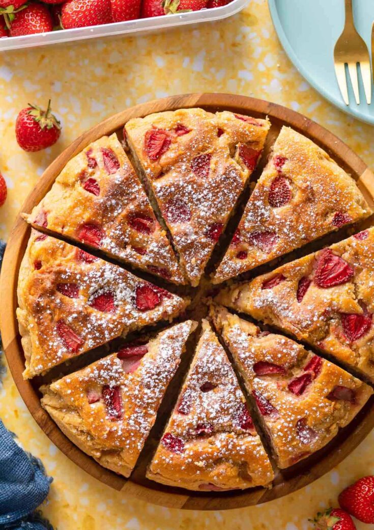 Strawberry Cornmeal Ricotta Cake cut into 8 slices and sprinkled with icing sugar