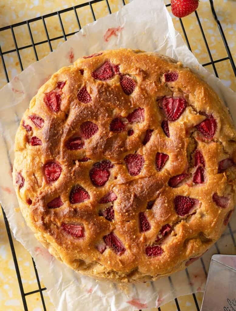 Strawberry Cornmeal Ricotta Cake cooling on a wire rack