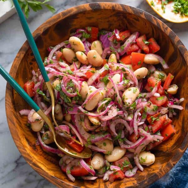 Piyaz - Turkish White Bean Salad with red onions, tomato and parsley in a big salad bowl