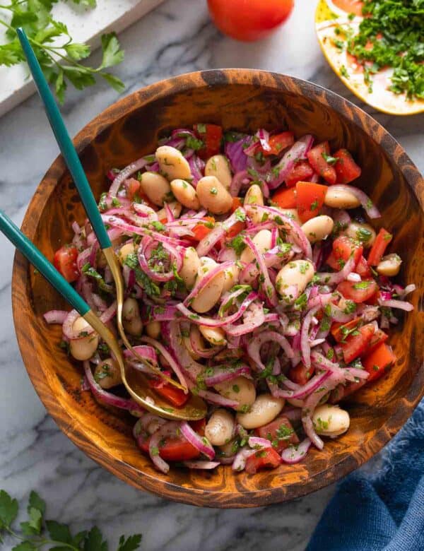 Piyaz - Turkish White Bean Salad with red onions, tomato and parsley in a big salad bowl