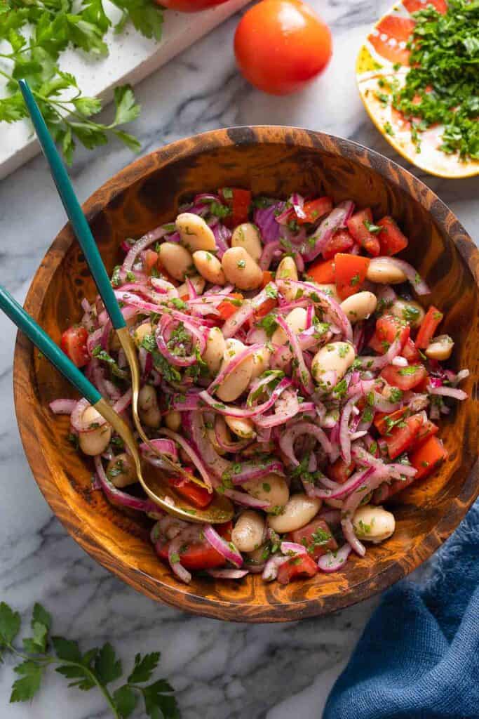 Piyaz - Turkish White Bean Salad with red onions, tomato and parsley in a big salad bowl