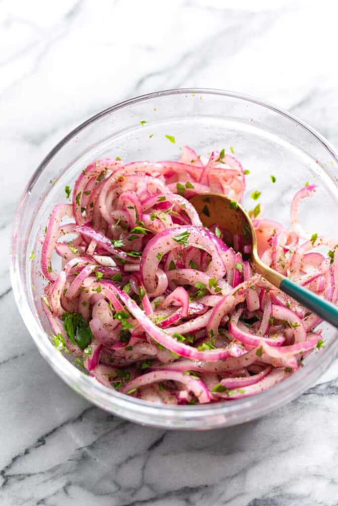 sumac onions with chopped parsley in a bowl