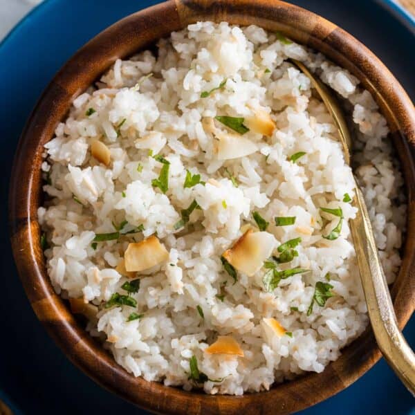 toasted coconut rice in a bowl with a serving spoon