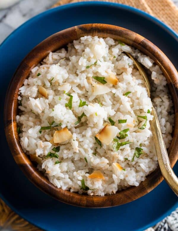 toasted coconut rice in a bowl with a serving spoon