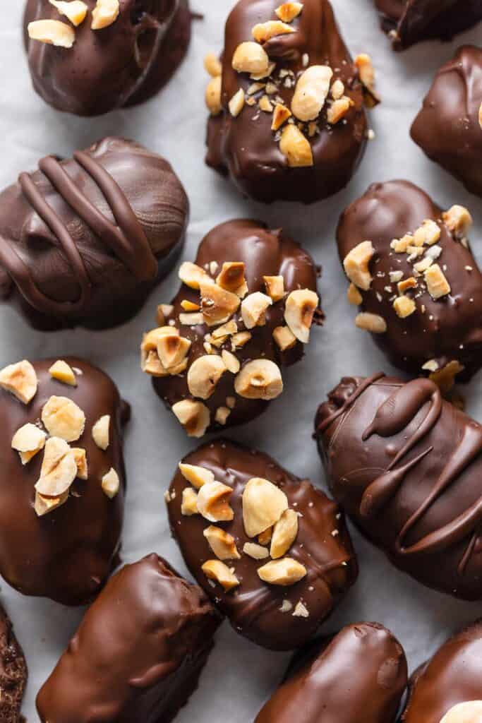 Chocolate Covered Dates with chopped peanuts and hazelnuts sprinkled on top
