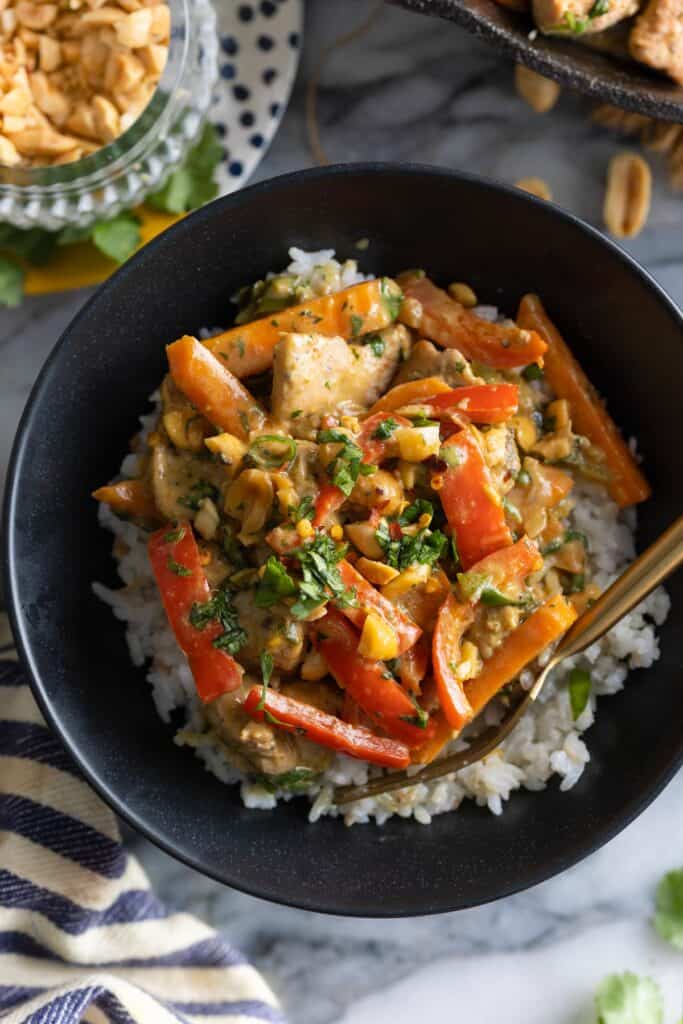 Peanut Chicken Stir Fry over a bed of rice topped with fresh chopped cilantro