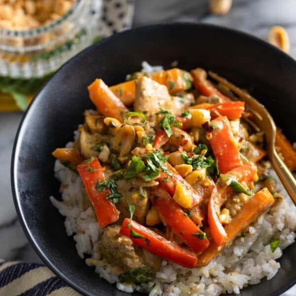 Peanut Chicken stir fry in a bowl over a bed of rice