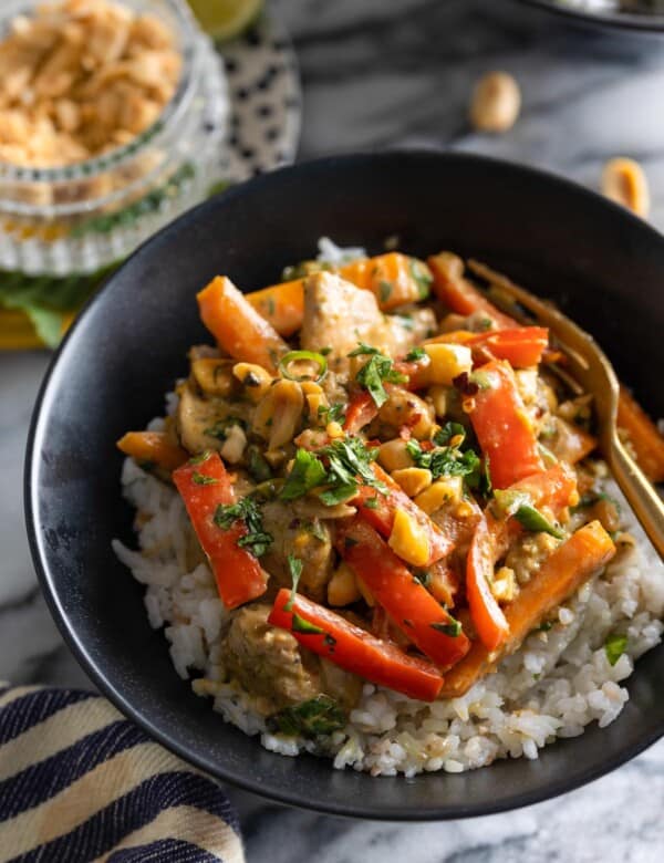 Peanut Chicken stir fry in a bowl over a bed of rice