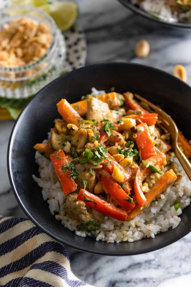 Peanut Chicken stir fry in a bowl over a bed of rice