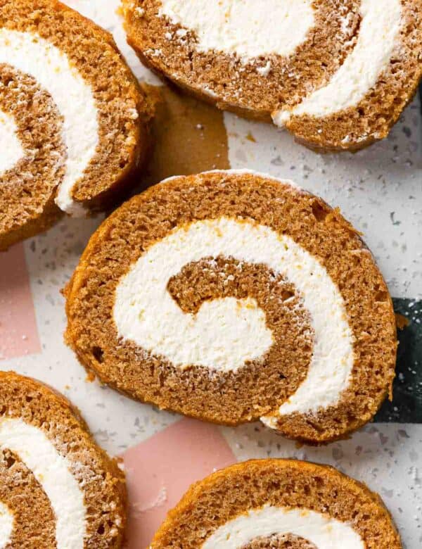 slices of Gluten Free Pumpkin Roll & Whipped Cream Cheese Frosting on a serving platter