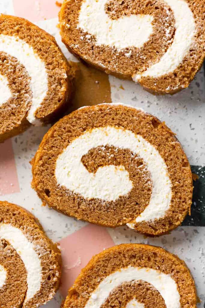 slices of Gluten Free Pumpkin Roll & Whipped Cream Cheese Frosting on a serving platter