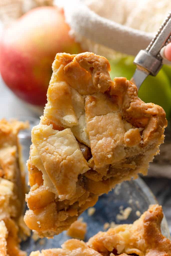 paleo apple pie slice held up on a serving knife
