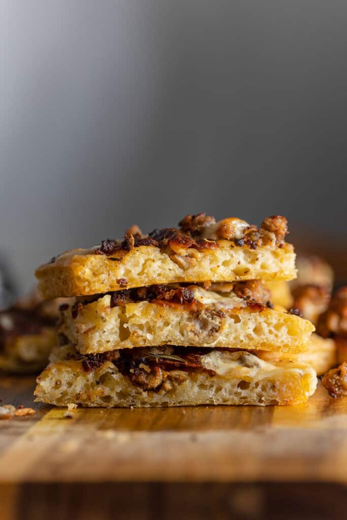 gluten free sausage focaccia bread cut into slices stacked on top of each other