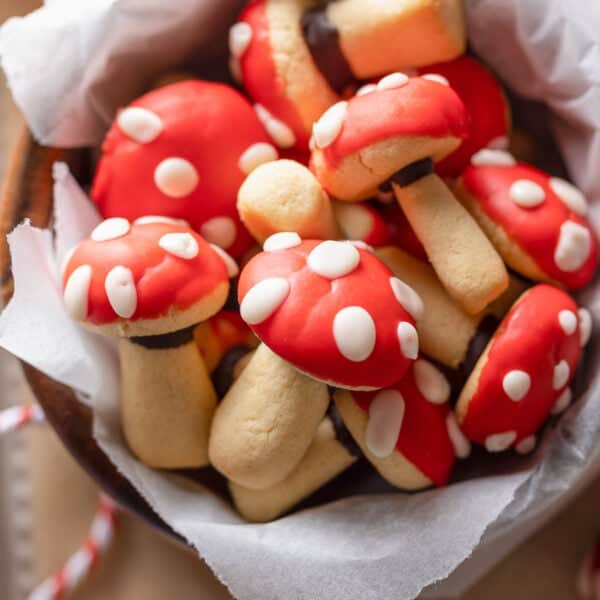 mushroom shaped sugar cookies decorated to look like red and white toadstool mushrooms