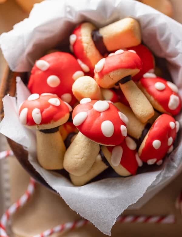mushroom shaped sugar cookies decorated to look like red and white toadstool mushrooms
