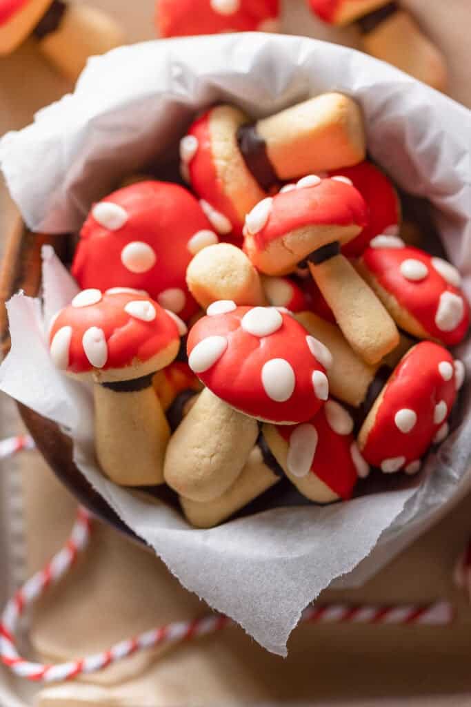 mushroom shaped sugar cookies decorated to look like red and white toadstool mushrooms