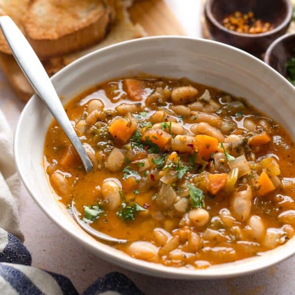 fasolada soup topped with fresh parsley and chili flakes