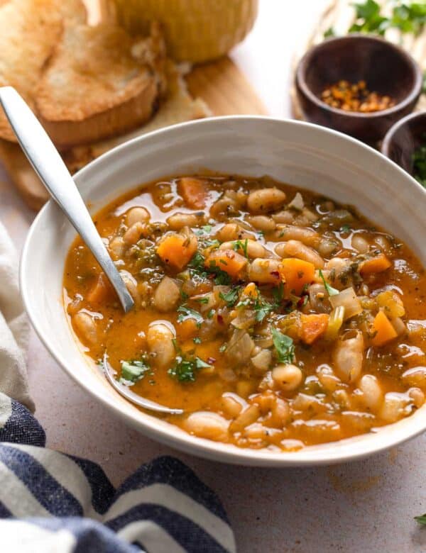 fasolada soup topped with fresh parsley and chili flakes