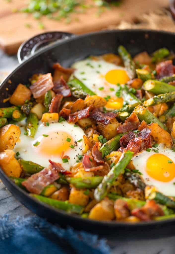 a cast iron hash with asparagus bacon and potato