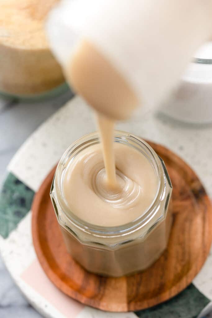 Homemade Coconut Milk Condensed Milk pouring into a storage jar