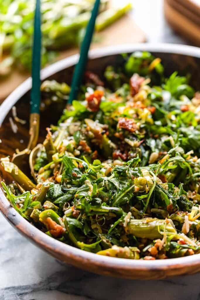 a salad bowl full of Sautéed Asparagus Salad with Sun-Dried Tomato